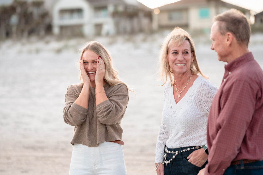 Rachel wiping happy tears while celebrating her engagement on Jacksonville Beach.