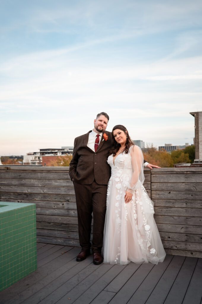 Couple sharing a joyful moment together during wedding portraits overlooking downtown Richmond.