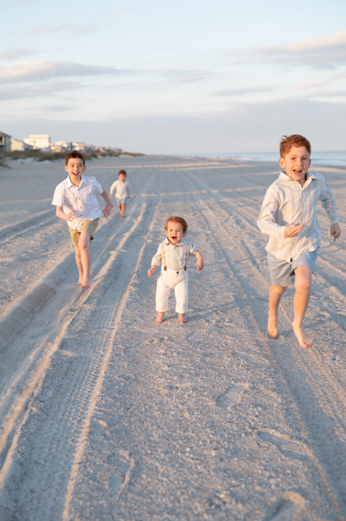 kids laughing running ocean edge candid