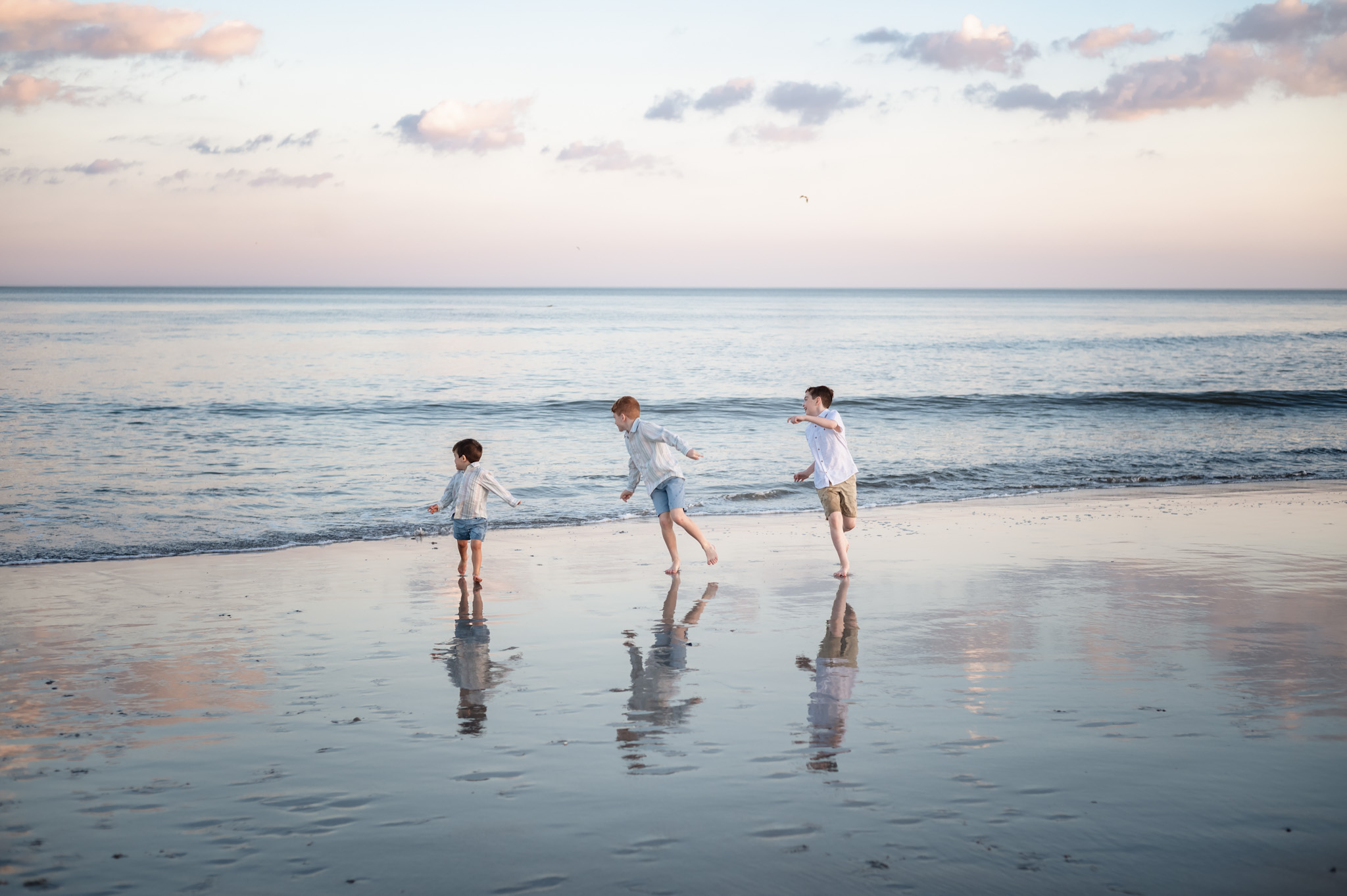 kids running along shoreline Fernandina Beach family session