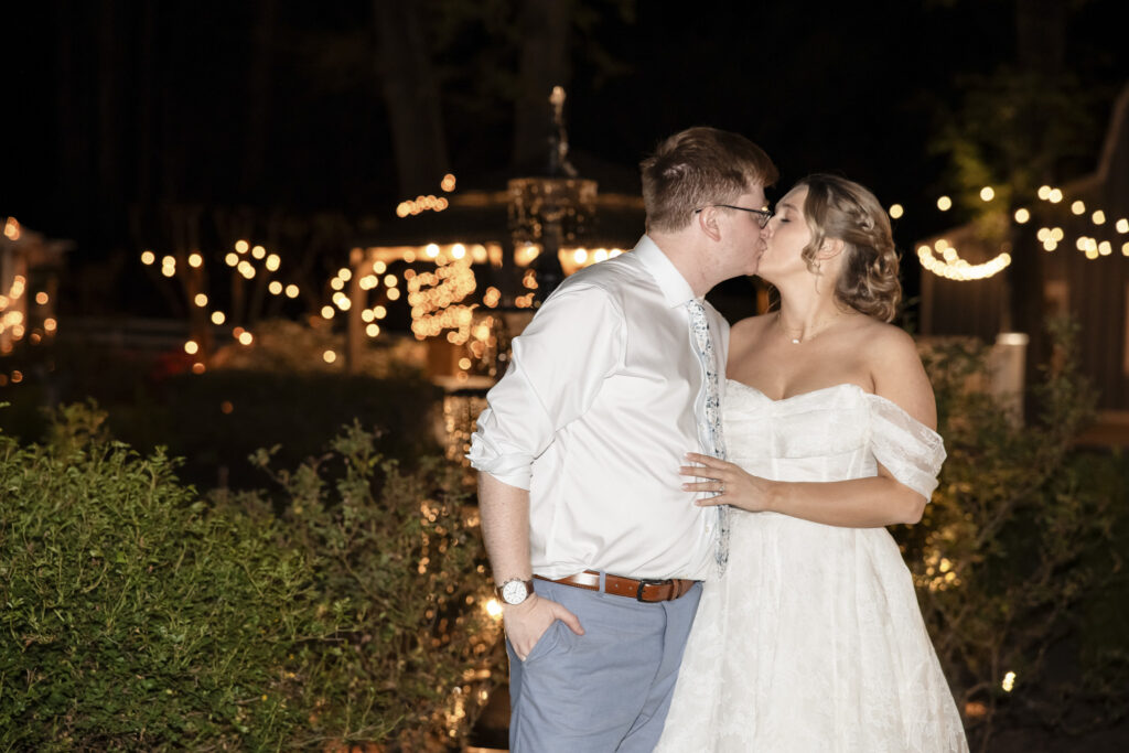 nighttime wedding portrait by fountain at Virginia Cliffe Inn