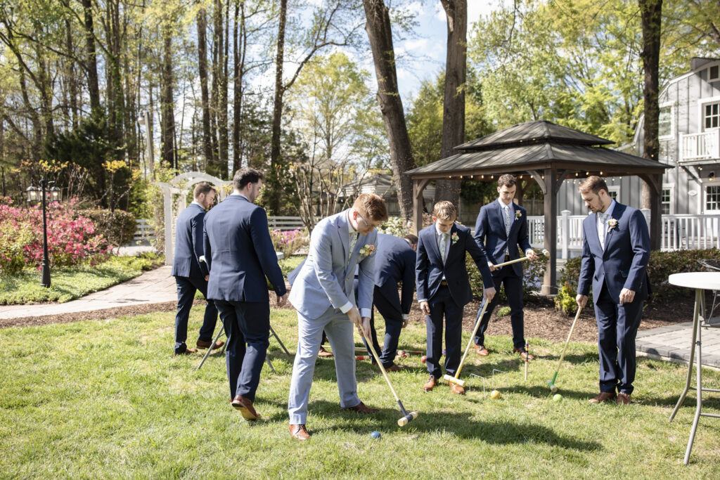 groomsmen playing croquet during wedding cocktail hour