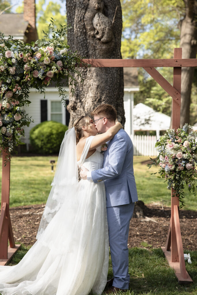 bride and groom first kiss after ceremony at Virginia Cliffe Inn