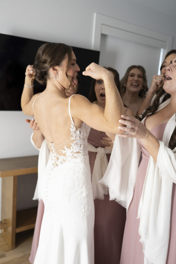 bride laughing with bridesmaids wedding morning