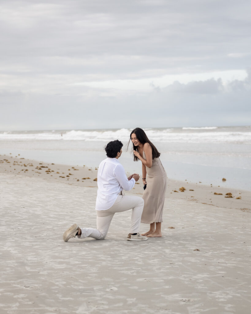 Kus getting down on one knee during a Crescent Beach proposal.