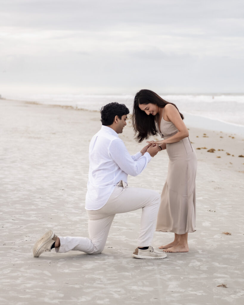 Kus proposing to Jahanvi on a quiet beach near Jacksonville.