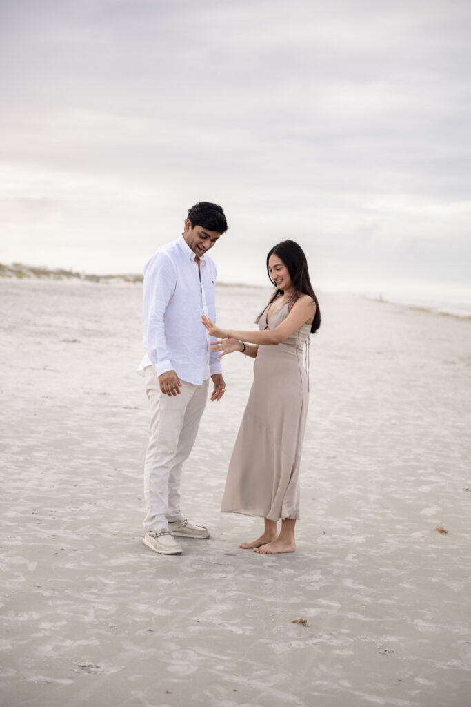Emotional surprise proposal on the shoreline in Florida.