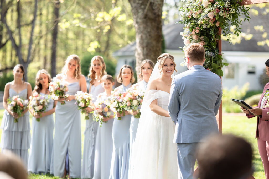 Couple exchanging vows during an outdoor wedding ceremony.