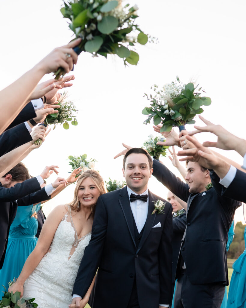 Newlyweds celebrating as they walk back down the aisle.